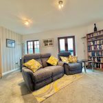 cosy living room with grey sofas and bookshelf