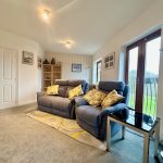 Cosy living room with sofa and natural light.