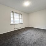 Empty room with carpet and window
