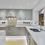 Modern kitchen with white cabinets and countertops.