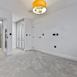 Minimalist grey bedroom with ensuite shower room