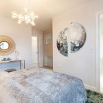 Modern bedroom with elegant decor and ensuite bathroom.