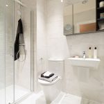 Modern white bathroom with shower and sink