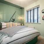 Stylish bedroom with striped bedding and decor accents.