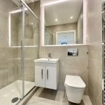 Modern bathroom with shower and stylish fixtures