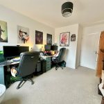 Home office with two desks and computers.