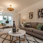 Modern living room with grey sofa and abstract art.