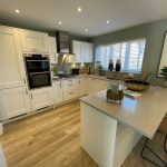 Modern kitchen with island and white cabinets