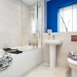 Modern bathroom with bathtub, sink, and toilet.