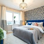 Modern bedroom with patterned wallpaper and stylish decor.