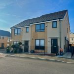Modern semi-detached house on a sunny day.