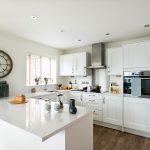 Modern white kitchen with wooden flooring