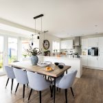 Modern kitchen dining room with wooden table.
