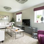 Modern living room with purple accents and furniture.