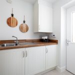 Modern kitchen with wooden countertops and sink.