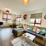 Cosy living room with modern decor and dining area.