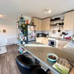 Modern kitchen with appliances and breakfast bar.