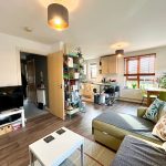 Cosy living room with kitchen and dining area.