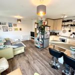 Modern open-plan kitchen and living room design.