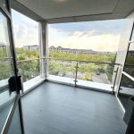 Modern balcony with city and tree view.