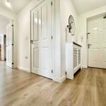 Modern white hallway with wooden flooring
