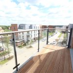 Modern balcony view overlooking residential street.