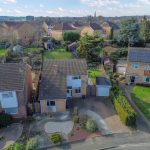 Aerial view of suburban houses and gardens.