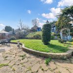 Sunny garden with patio and seating area