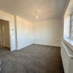 Empty room with grey carpet and large window