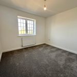 Empty room with carpet and window.