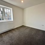 Bright empty room with window and radiator