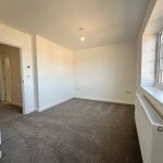 Bright empty room with carpet and large window.