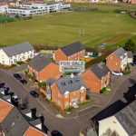 Aerial view of a suburban house for sale.