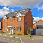 Modern brick house with blue sky background.