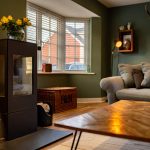 Cosy living room with wood-burning stove and sofa.