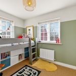Child's bedroom with bunk bed and toys.