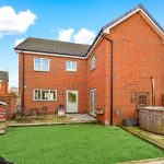 Red brick house with patio and garden