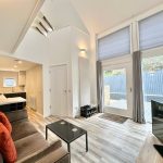 Modern open-plan living room with large windows