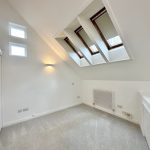 Bright room with skylights and sloped ceiling.