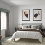 Modern bedroom with grey decor and artistic paintings.