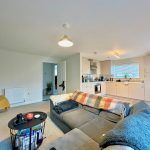 Modern open-plan living room and kitchen.