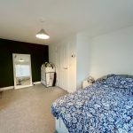 Bedroom with double bed and large mirror