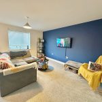 Modern living room with blue accent wall.