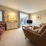 Cosy living room with sofas and TV.