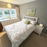 Cosy bedroom with double bed and chest of drawers.