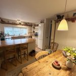 Cosy kitchen with wooden furniture and warm lighting.