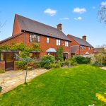 Brick house with garden and patio area
