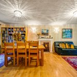 Cosy living room with bookcase and fireplace.