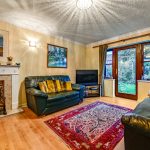 Cosy living room with sofas and garden view.