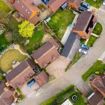 Aerial view of suburban houses and gardens.